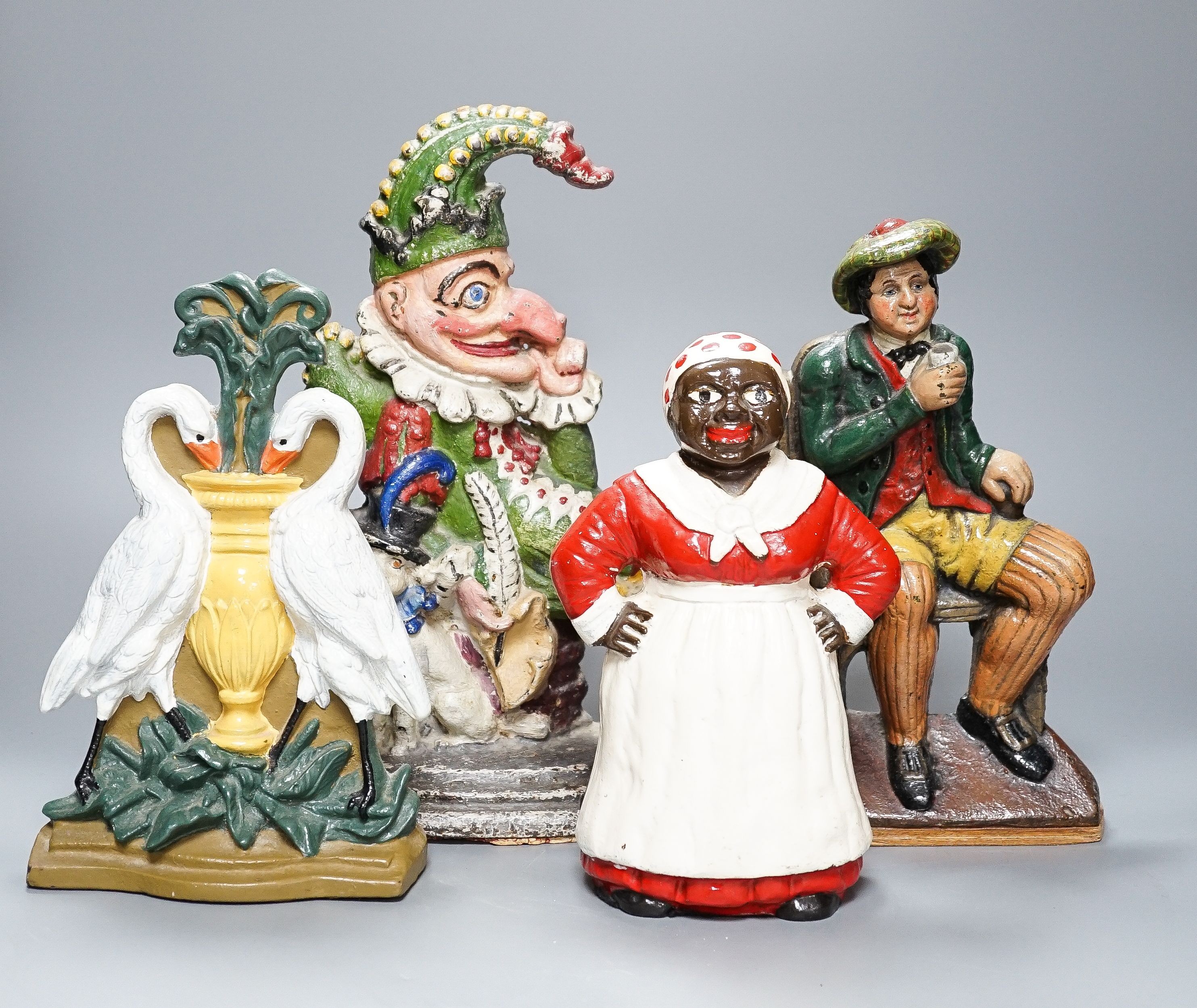 Three Victorian painted cast iron door stops (re-painted) 31cm and a later figure